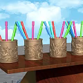 Colorful Pens in Carved Metal Holders on Wooden Shelf With Blue Sky Background