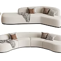 Curved Beige Sectional Sofa With Throw Pillows Blanket And Side Table Rabbit Decor