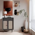 Gray Sideboard with Rattan Doors Table Lamp Books Green Plant and White Vase