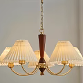 Elegant Chandelier With Multiple Cream Pleated Lampshades And Golden Metal Frame