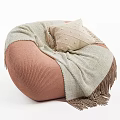 Cozy Pink Bean Bag Chair With Soft Beige Fringed Blanket And Cushion
