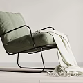 Light Green Fabric Accent Chair with Black Metal Frame and White Throw Blanket