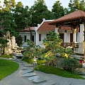 Traditional Garden Landscape Design With Pavilion Lush Green Plants Lawn And Stone Pathway
