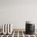 Curved White Stool And Black Perforated Stool With Dotted Seat On Checkerboard Rug