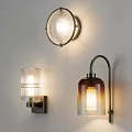 Various Modern Wall Lamps With Glass Shades And Metal Bases For Indoor Lighting