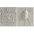 White Wall Decor Featuring Relief Text Patterns And Abstract Sculptural Design