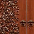 Brown And Silver Carved Double Doors With Intricate Patterns And Decorative Handles