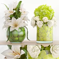 Glass Vases With White Lilies Roses And Green Decorative Elements On Wooden Surface