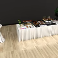 Long White Display Counter Decorated With Various Desserts Wine Glasses And Flower Bouquets