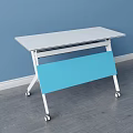 White Tabletop Desk With Blue Panel Sturdy White Frame And Wheels On Gray Floor