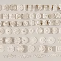 Collection Of White Carved Decorative Pieces With Floral Circular And Geometric Patterns