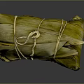 Traditional Chinese Zongzi Wrapped in Green Bamboo Leaves and Tied with String on Dark Glossy Surface