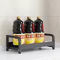 Three Black Condiment Bottles with Yellow Labels on Kitchen Storage Rack 3d model