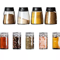 Assorted Spice Jars with Black and Clear Lids Containing Various Seasonings