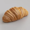 Freshly Baked Croissant With Golden Brown Exterior And Flaky Buttery Layers On Light Background