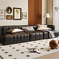 Black Three Seater Leather Sofa With Pillows On Patterned Rug And Wall Art Near Lamp