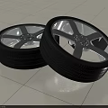 Pair of Car Tires With Silver Alloy Rims And Detailed Tread Pattern Design
