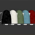 Assorted Colored Electric Kettles with Silver Handles on Reflective Surface