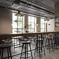 Industrial Style Restaurant Interior With High Ceilings Pendant Lights Bar Counter And Stools