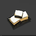 Three Square Flaky Pastry Pieces Topped with White Frosting on Black Plate