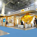 Modern Exhibition Booth Design With Yellow White Decor Display Screen Tree And Visitor Interaction 3d model