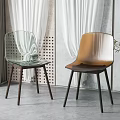 Modern Transparent and Golden Dining Chairs with Dark Legs Near White Curtains and Green Plant