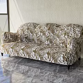 Multi Seater Sofa In Gold And White Leaf Pattern Against Light Wall With Marble Floor 3d model