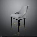 Light Colored Upholstered Bar Stool With Black Legs And Gold Accents