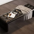 Black Leather Tufted Bench With Magazine And Plaid Blanket On Wooden Floor