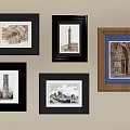 Various Framed Decorative Artworks With Architectural Prints On Beige Wall