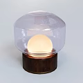 Modern Table Lamp With Transparent Dome Shade And Illuminated Spherical Bulb On Wooden Base