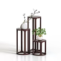 Modern Three Dark Brown Plant Stands With Varying Heights And Green Plants White Vases