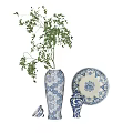 Elegant Blue and White Patterned Vase With Green Foliage Decorative Plate And Ornament
