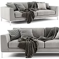 Cozy Gray Two Seater Sofa With Textured Pillows And Blankets For Living Room