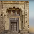 Traditional Stone Entrance Gate With Arched Top Intricate Carvings And Decorative Elements