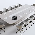 Modern Conference Table With Gray Rolling Chairs And Name Cards On Top