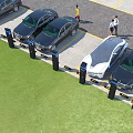 Parking Lot Scene with Multiple Cars Parked Near Charging Devices and People Walking