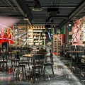 Vintage Bar Interior Design With Retro Posters Wooden Tables And Green Plants