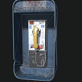 Vintage Public Telephone In Blue Booth With Yellow Handset And Keypad Stickers