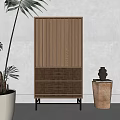 Wooden Entryway Side Cabinet With Vertical Slats Black Legs Near Large Green Plant Decorative Vase