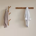 Wooden Tree Shaped And Long Bar Hangers With Checkered And Striped Garments On Light Wall