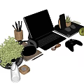 Modern Laptop and Tablet Desk Setup With Headphones Game Controller Green Plants and Pencil Holders