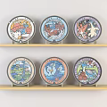 Colorful Decorative Plates On Wooden Shelves With Various Animal Nature Designs