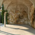 European Architecture Arched Structure Featuring Stone Columns Ivy Plants Weathered Walls And Sunlight Shadows