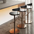 Modern Bar Stools With Black Padded Seats And Copper Metal Frames By Bar Counter