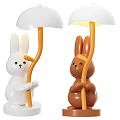 Cute Rabbit Shaped Table Lamp With White Brown Body Orange Stand And Yellow Light