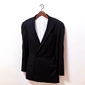 Black Double Breasted Suit Jacket Hanging On Wooden Hanger With White Shirt Inside
