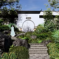 Rockery Stones in Traditional Chinese Garden with Lush Greenery Stone Steps and Round Gate