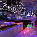 Modern Bar Interior With Stage Leather Sofas Colorful Lighting And Sound System