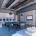 Modern Industrial Entertainment Room With Ping Pong Table Multiple TVs Gray Walls And Blue Carpet